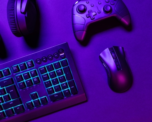 top-view-of-illuminated-gaming-gadgets-on-purple-d-2023-11-27-04-58-57-utc-495x400