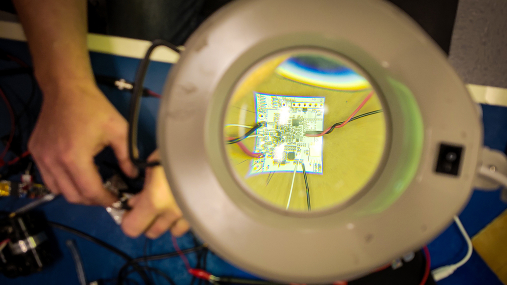 looking_through_magnifier_to_chip_small-1030x580