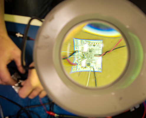 Circuit Board Seen through Magnifying Glass